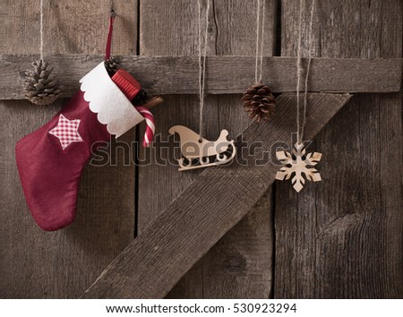 Christmas sock with gifts on  wooden door