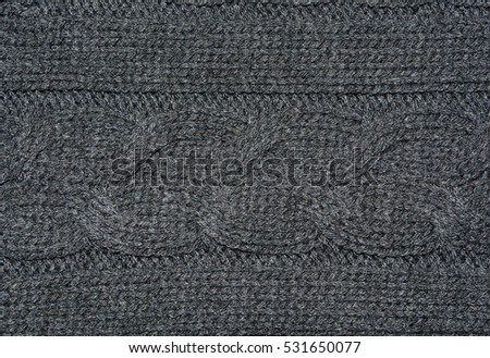 Dark gray knitted background texture.