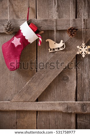 Christmas sock  with gifts on  wooden wall
