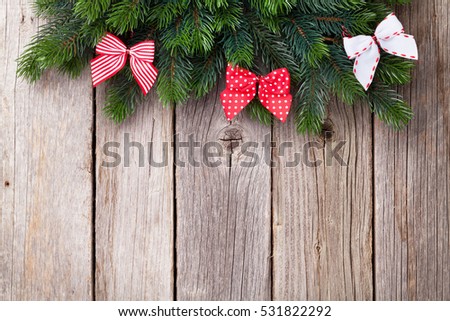 Christmas wooden background with fir tree and ribbon bow. View with copy space for your text