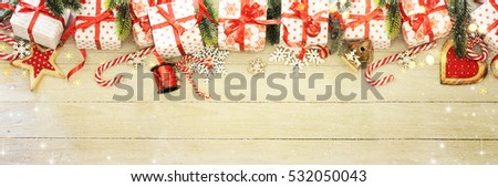Gift boxes and Christmas ornaments on wood background, border design, top view