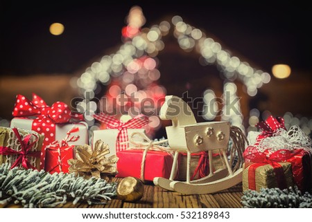 Rocking horse and handmade Christmas decorations on wooden boards

