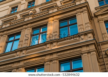orange facade with ornaments and blue windows