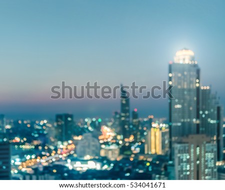 Blur background rooftop party view of Bangkok downtown city night lights colorful bokeh
