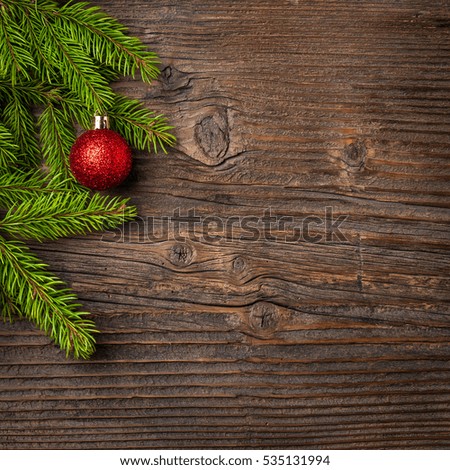Christmas tree and red ball on wooden background