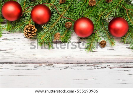 Christmas card decoration  fir and ornaments on wooden background