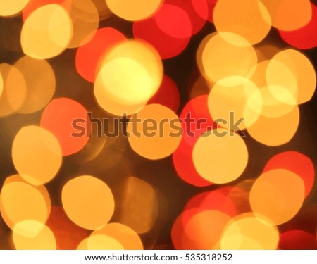 Golden and red Christmas lights blurred in the background