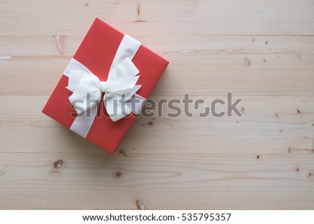 Red gift boxes on wooden floor concept for Happy new year and Christmas concept