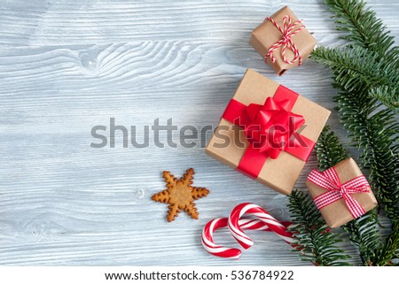 Christmas wood background with christmas gift and candy cane, top view