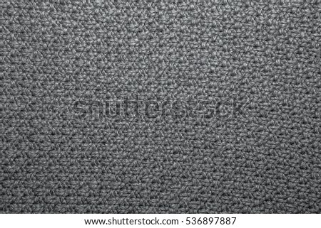 Seed stitch in brown yarn as an abstract background texture