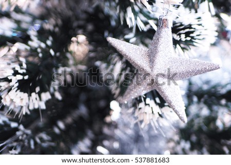 Soft focus of Christmas decoration star on christmas tree.