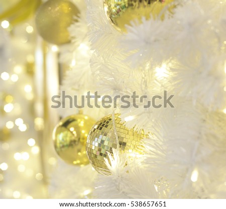 christmas decorative balls on white christmas tree with lighting