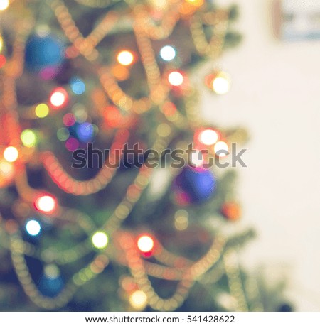 Abstract christmas background with christmas tree with decorations, defocused bokeh lights.