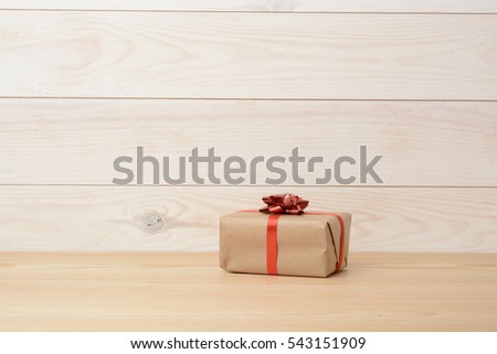 Gift box on wooden white background, white wood