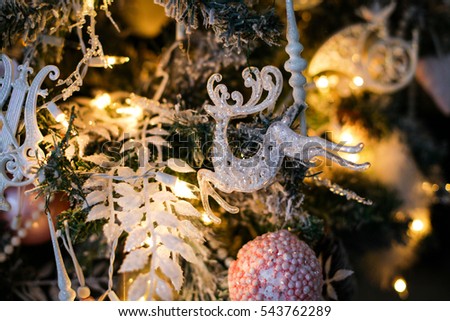 Christmas tree decorations - a toy raindeer hanging on a branch