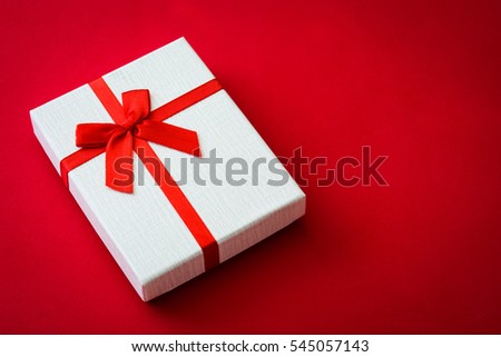 San Valentine white gift box on red background.Love concept Copyspace.


