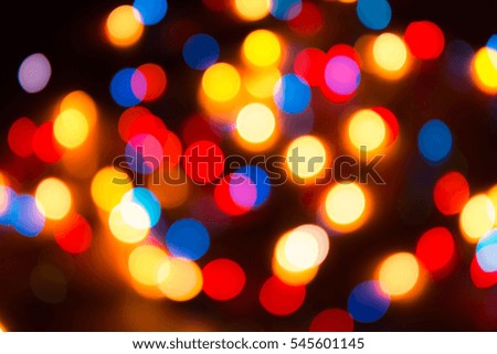 Blurry abstract colorful background. Colored Christmas garland. Bokeh and defocusing of the lens