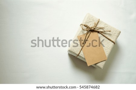 gift box with craft card on white light background.