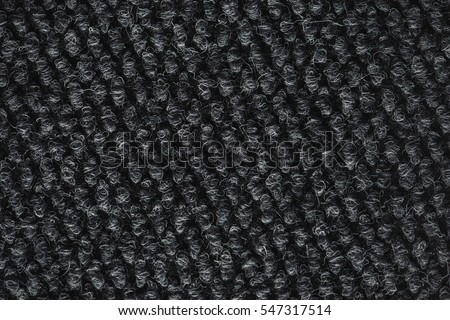 Rough dark carpet texture as background, macro