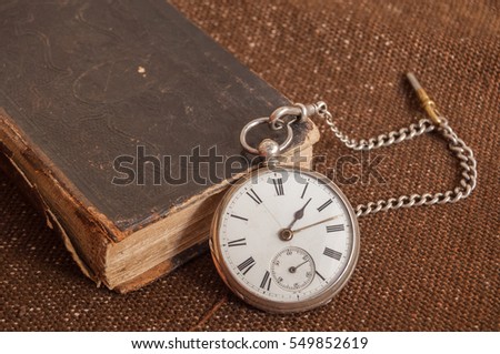 Pocket watch and old Bible