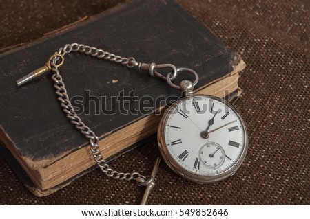Pocket watch and old Bible