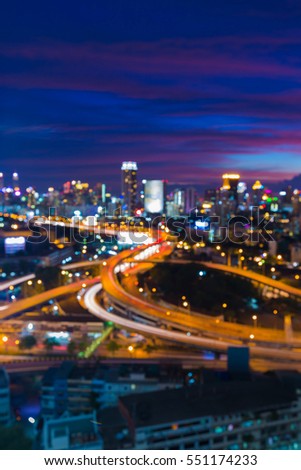 Blurred lights highway interchanged with city downtown with beautiful after sunset sky background 