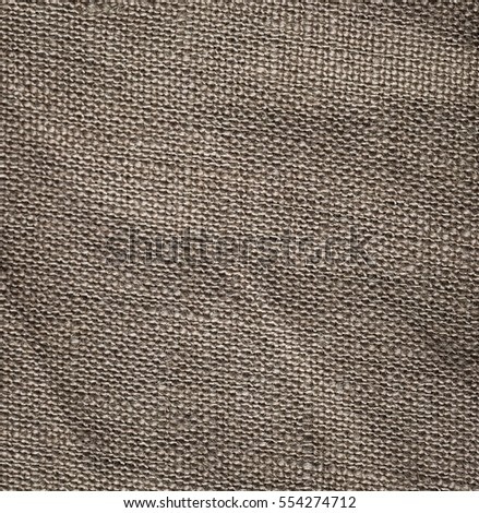 Burlap background in close up. Texture of color canvas useful as background.