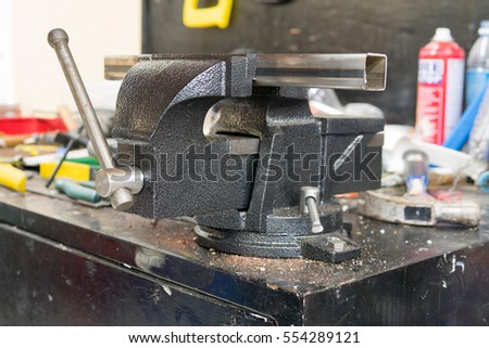 Bench vise locking a square steel tube