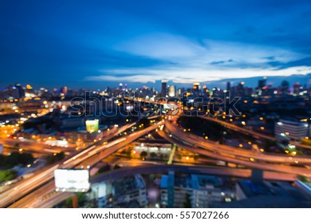 Blurred light highway interchanged with city downtown twilight skyline background