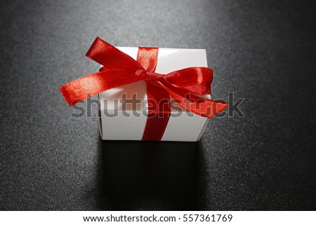 gift with red ribbon on black background (Valentine's gift)
