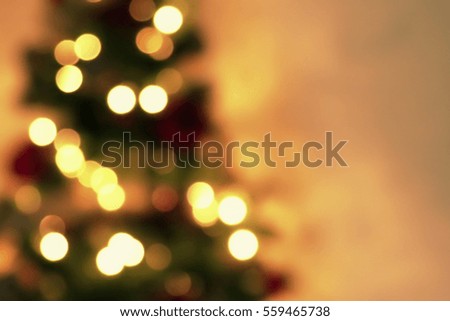 golden abstract blinking blurred Christmas tree lights bokeh on gold warm background, festive holiday concept