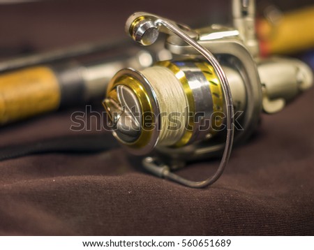 Beautiful gold fishing rod and reel closeup