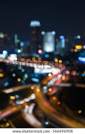 Night blurred bokeh light highway interchanged with city office background
