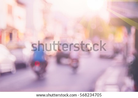 Blur traffic road with colorful bokeh light and old building town abstract background. Copy space of transportation and travel concept. Retro tone filter effect color style.