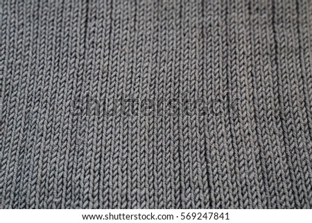 Close-up of seamless gray knitted fabric texture.