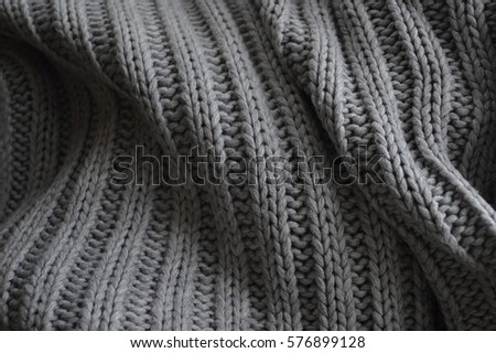Detail of woven woolen design texture. Fabric gray background