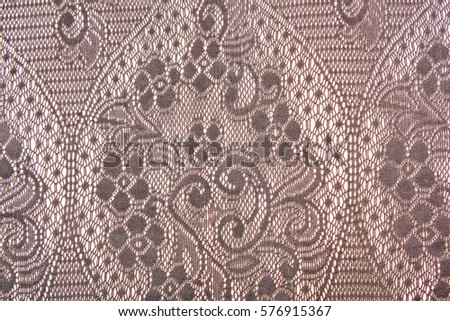 Crochet lace dress material cloth texture pattern. 
tailoring stitching concept. Shiny beautiful fashion fabric. Shiny clothing material sample.Creased fabric.
