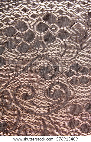 Crochet lace dress material cloth texture pattern. 
tailoring stitching concept. Shiny beautiful fashion fabric. Shiny clothing material sample.Creased fabric.