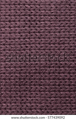 The texture of a knitted sweater wallpaper. Woolen fabric for wallpaper and an abstract background