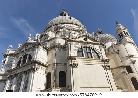 Basilica di Santa Maria della Salute facade against clear blue sky in Venice, Italy.