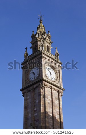 Albert Memorial clock tower in Belfast in Northern Ireland against blue skies