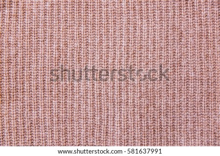 The texture of a knitted sweater wallpaper. Cashmere fabric for wallpaper and an abstract background. Macro