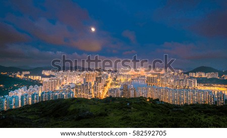 Long exposure Victoria peak, victoria harbor, Hongkong city, Kowloon city and building view with moon, Hong kong, China