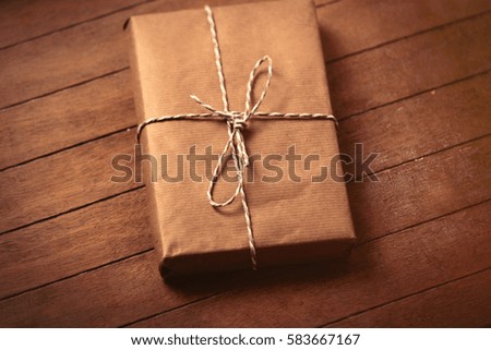 beautiful gift lying on the wonderful brown wooden background