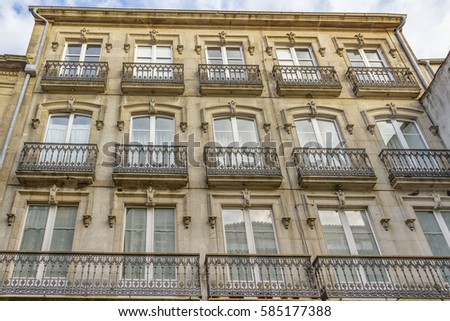 Old building with facade covered with balconies in Santiago de Compostela