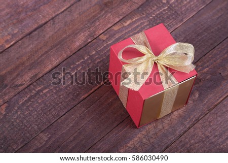 Gift boxes with bow on wood background.