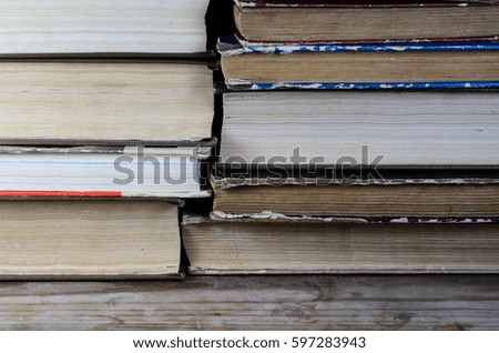 Stack of the different books on wooden table