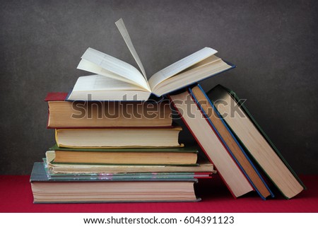 the stack of books on table on dark background
