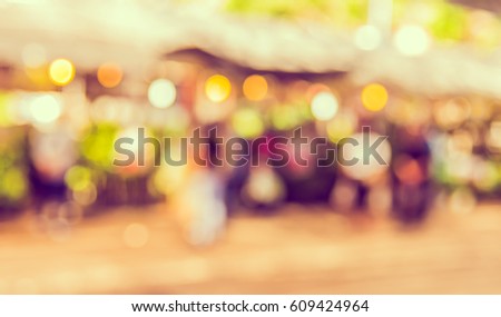 vintage tone blur image of day market on street with bokeh for background usage .