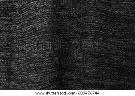 Black knit background texture.